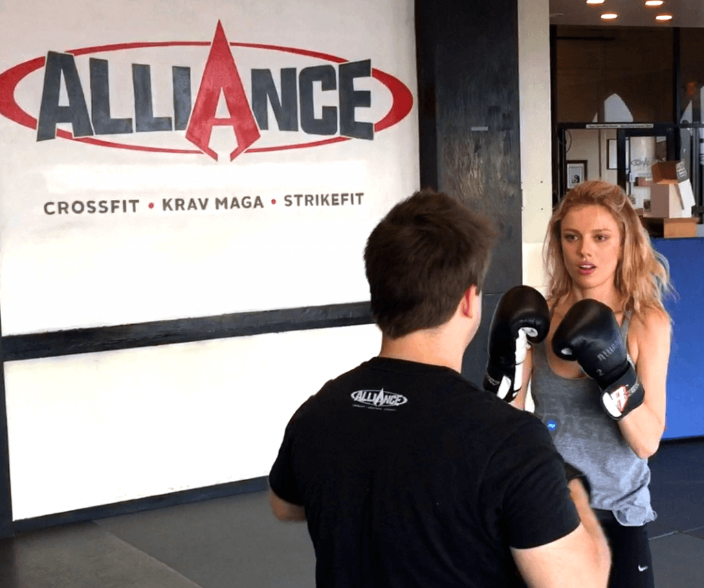 Athlete practicing boxing combinations with a coach at Alliance