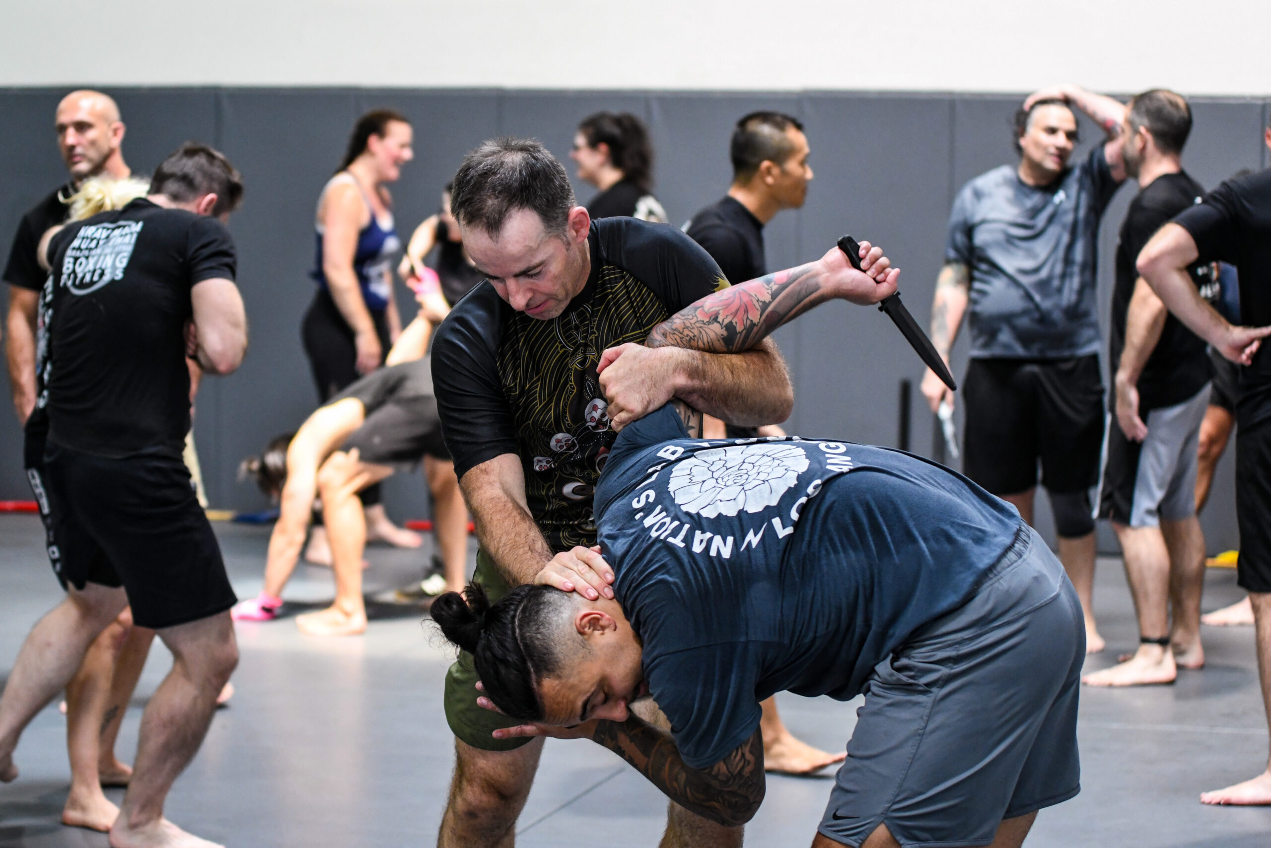 Alliance members practicing partner exercises in a group training session